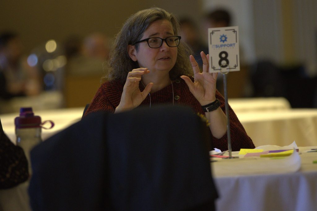 Sara Nagreen discussing at a round table with Colleagues