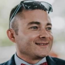 Pat Daley with sunglasses on his forehead looking off to the side.